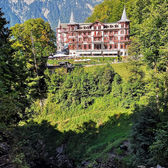 View of the historic Grandhotel Giessbach above Lake Brienz – surrounded by forest, waterfalls and Belle Époque charm.