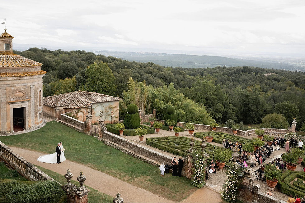 Guests seated at outdoor wedding ceremony in Tuscany