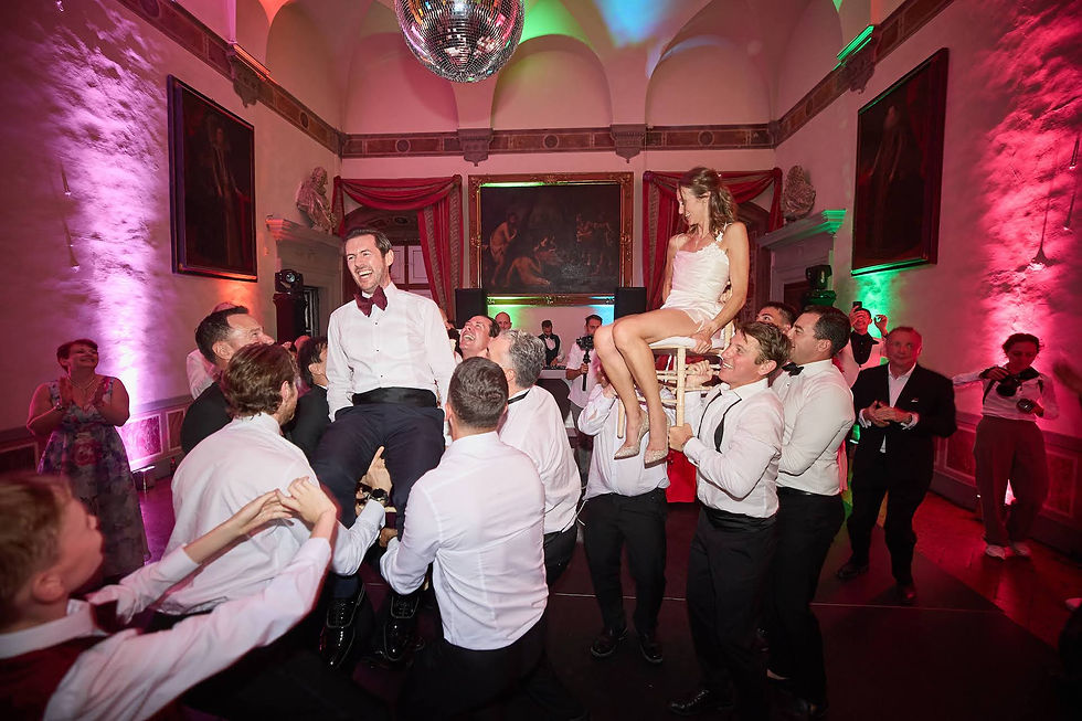 Bride and groom lifted during the hora dance at an Italian wedding reception at Villa Corsini