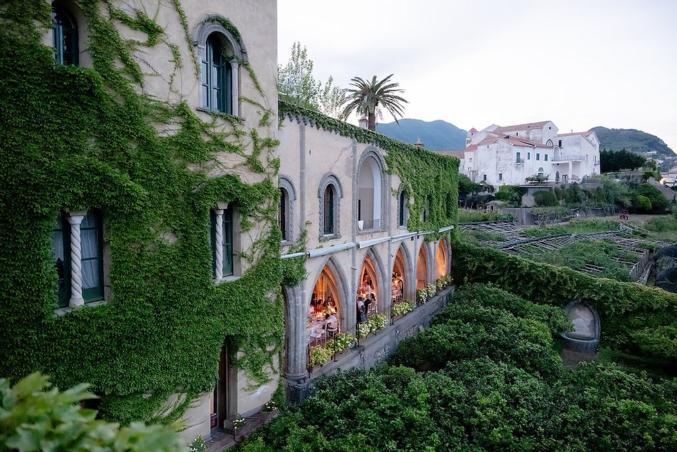 Destination wedding dinner beneath the historic arches and gardens of Villa Cimbrone in Ravello, Italy