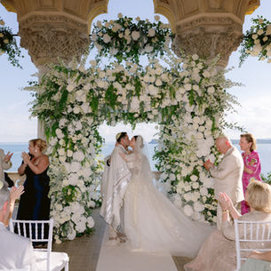 Luxury Jewish wedding ceremony beneath a floral chuppah at Lake Garda