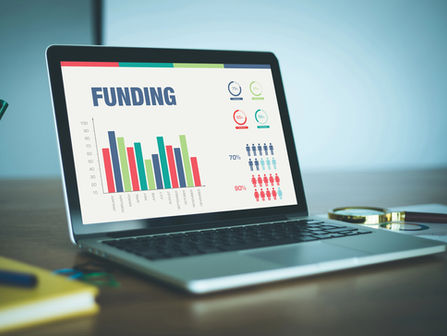 funding stats and graphs on laptop screen 