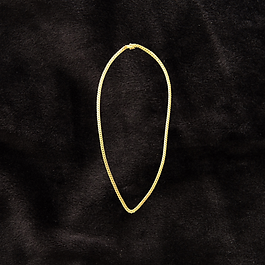 14K solid gold Cuban link chain with secure box clasp and dual figure-8 safety locks, 24 inch length displayed against black velvet.