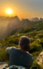 Hiker watching a private sunrise and guided hike tour view.