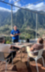 Wine tour tasting with mountain views in the vineyard.