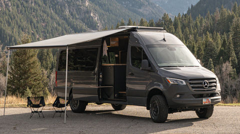 Camper vans made complete with awnings to get out of the hot Utah summer sun.