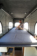 This Mercedes Sprinter has a pop-top installed on top, making camping anywhere beautiful and comfortable