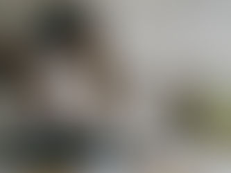 woman smiling and working on laptop with coffee