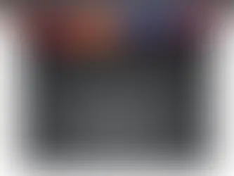 Top view of an open laptop with a colorful abstract screen. Black keyboard, large touchpad. Modern and sleek design.