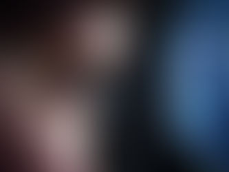 Close-up of an eye looking at a computer screen displaying colorful code graphs. Dark room, focused and curious mood.