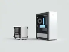 White and black desktop computers on a light background. One small cube-shaped, the other larger with visible blue lighting inside. Minimalist design.