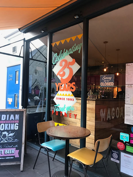 hand painted colourful window splash for restaurant celebrating 25 years