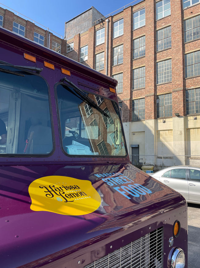front of a food truck with hand painted lettering