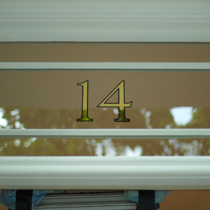 mirror gold leaf house number on glass window 