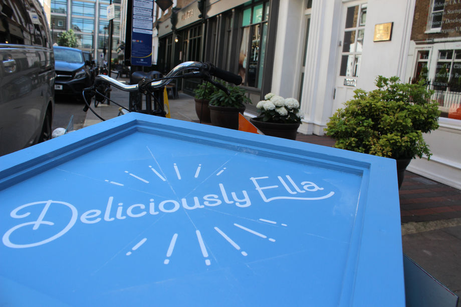 Hand painted logo on a swing sign for outside a shop