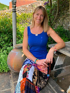 Lizzie, psychotherapist at Pandora Psychotherapy, sitting in a garden