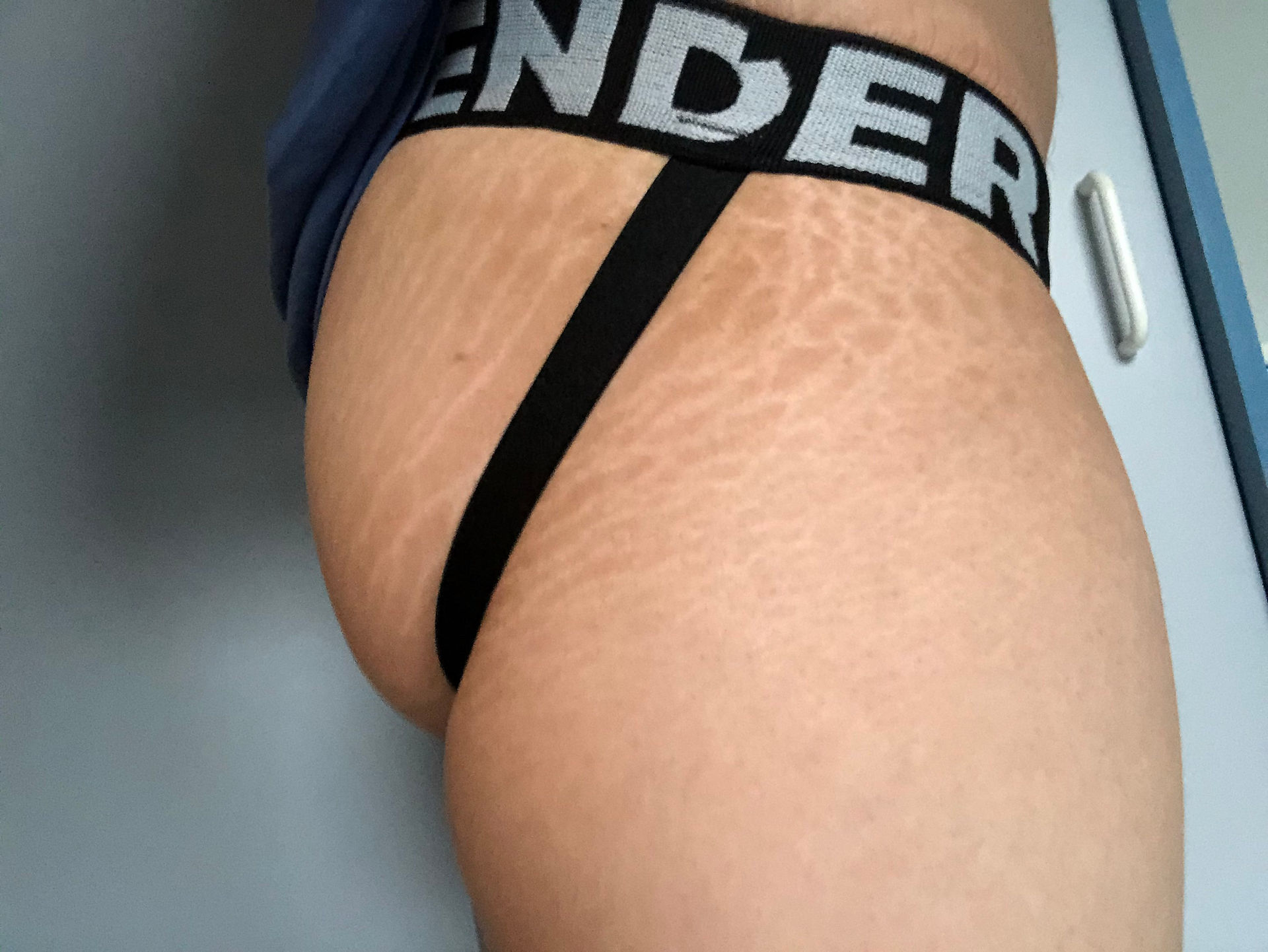 Wearing Gender Jockstrap with Xmall strapped down side view 2