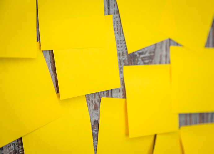 many-yellow-post-it-stuck-wall.jpeg