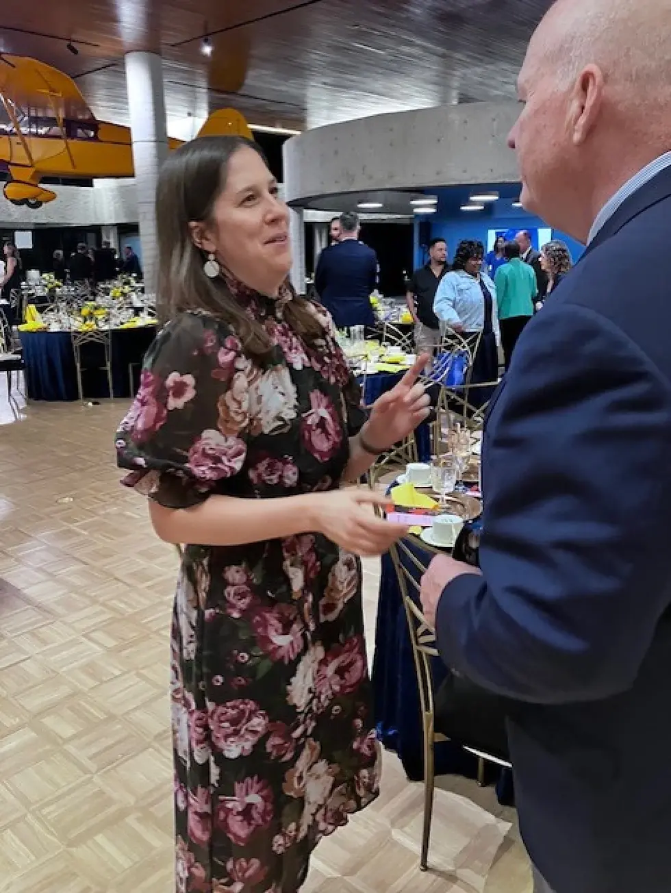 Kansas Museum of History Director Sarah Bell talking with Carl Ice, former President & CEO of BSNF Railway, at a recent dinner for donors to the museum’s $6 million renovation. (Jim McLean / KPR News)