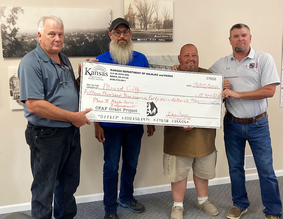 Don George, from left, presents a check to city staff members Jacob Bush, John Bruns and Mayor Wade Doering for phase two work on the city lake under the Kansas Department of Fish and Wildlife's Angler Access Program. (Roger Sims / Linn County Journal)