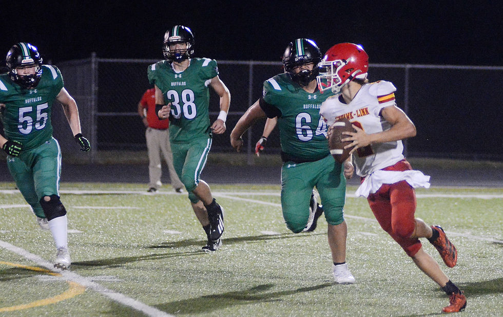 Prairie View defenders Boden Hughes (55), Kalven Shelton (38), and Wilber Alvarez (64) push Jayhawk quarterback Londonn Burk out of the pocket during the game Friday at Prairie View. (Photos by Roger Sims / Linn County Journal)