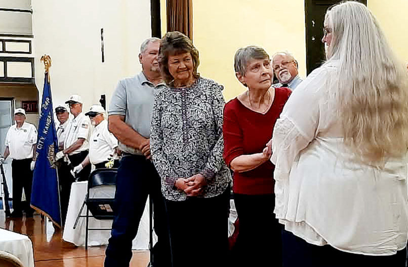 Sheryl Wallace, daughter of Irvin Endecott, receives a plaque honoring her father's service from Raquel Beltz during the ceremony. (Submitted photo)