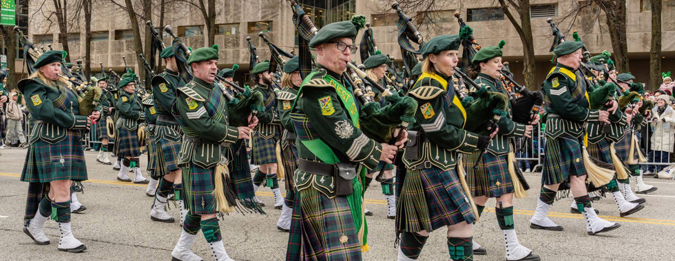 Bagpipers from Shannon Rovers Irish Pipe Band perform Irish music as they march Columbus Drive