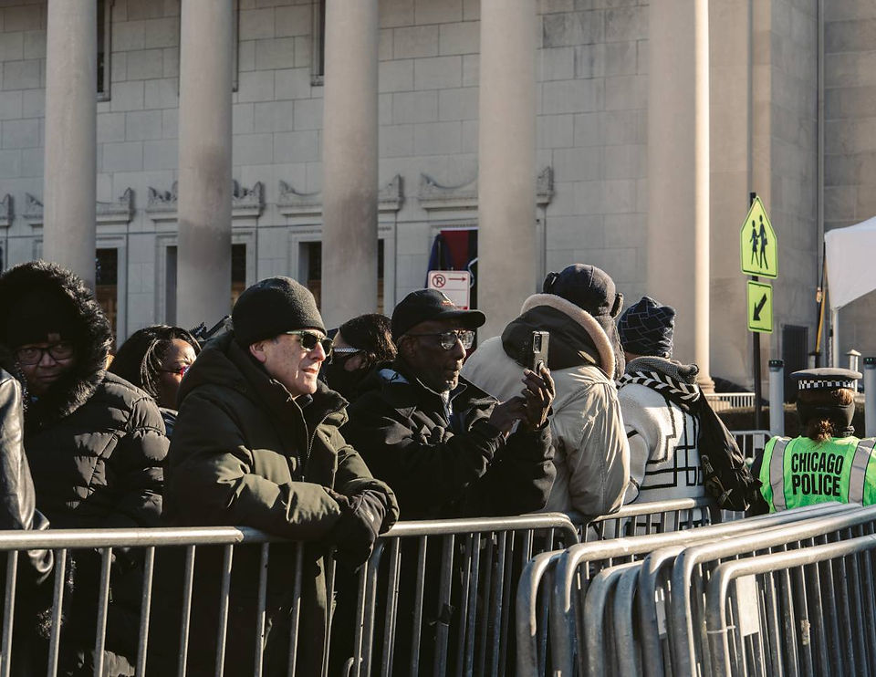 Supporter uses phone to capture moments while outside Rainbow PUSH Coalition | Miguel Guerrero