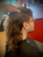 Alternative barber styling a curly mullet