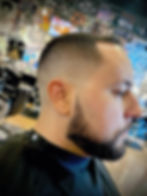 Alternative barber hair stylist's fresh fade and beard