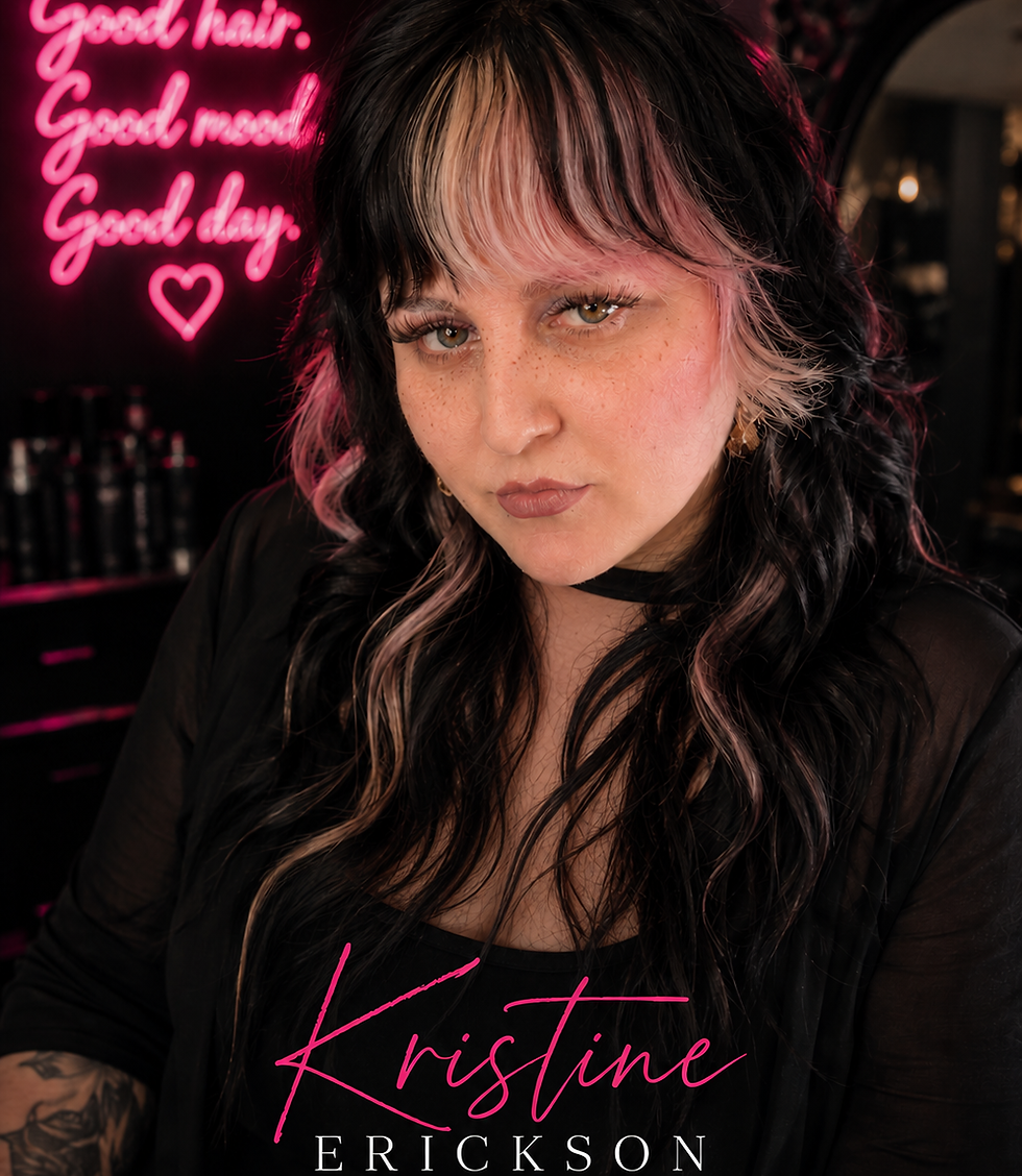 Kristine Erickson, alternative hair stylist, with "Good hair" neon sign
