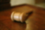 Auction: a wooden gavel sits on top of a wooden table at an auction.