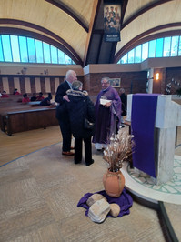 Bishop Pery talks with parishioners after Mass