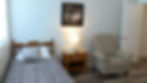 Comfortable resident room with single bed and armchair