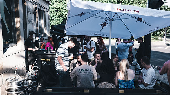People enjoying pints in the sun outside Simz Golf on Abbeydale Road in Sheffield