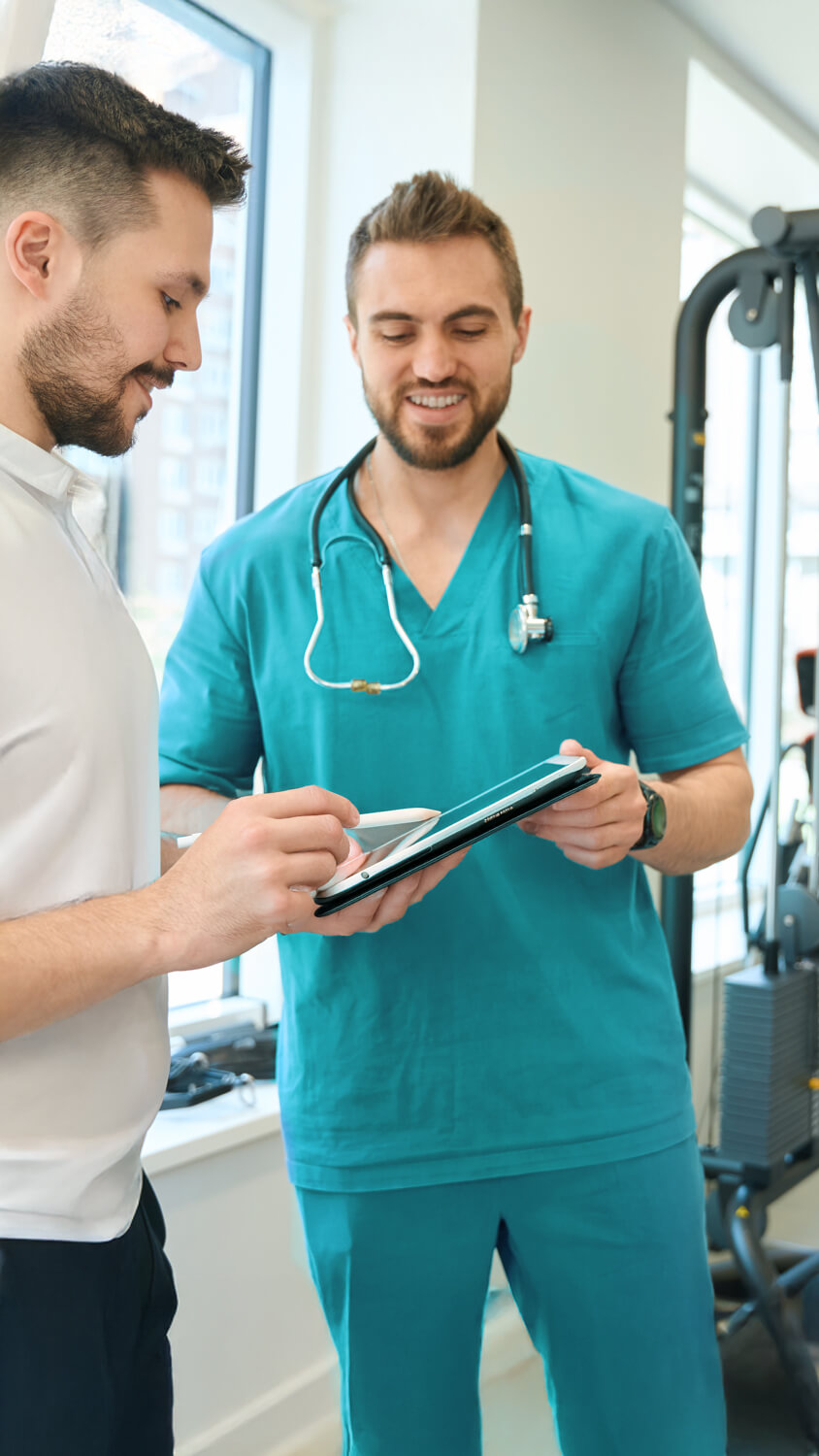 physician-and-gym-trainer-discussing-patient-physi-2024-10-18-08-39-19-utc (1).jpg