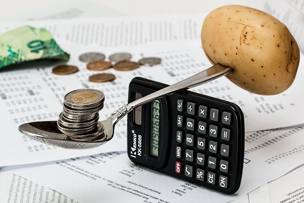 Coins balanced on a spoon above a calculator and paperwork, symbolizing customer acquisition cost and optimized growth strategy.