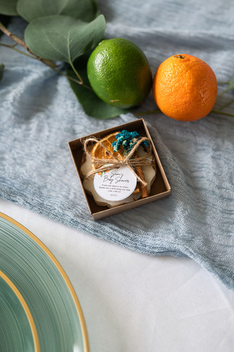 Baby shower details of tablecloth, place setting, and party favors in Gainesville, Florida