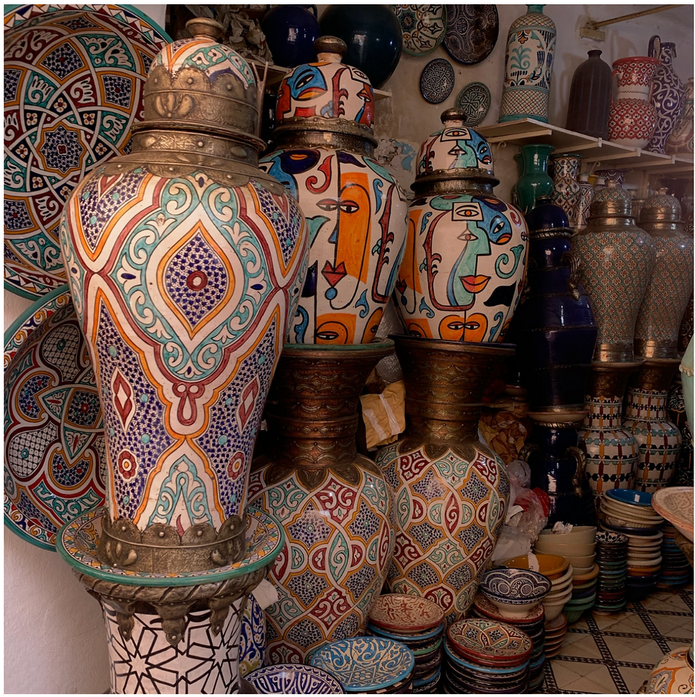 Hand-painted Moroccan pottery and traditional ceramic vessels displayed in a Marrakech market