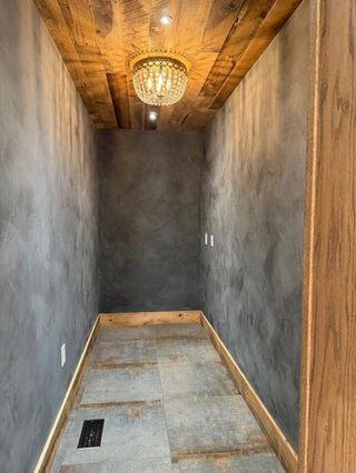 Black limewash living room with textured walls handcrafted by Limewash Painting LLC in Middle Tennessee.