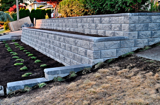 Retaining wall with gray blocks and plants