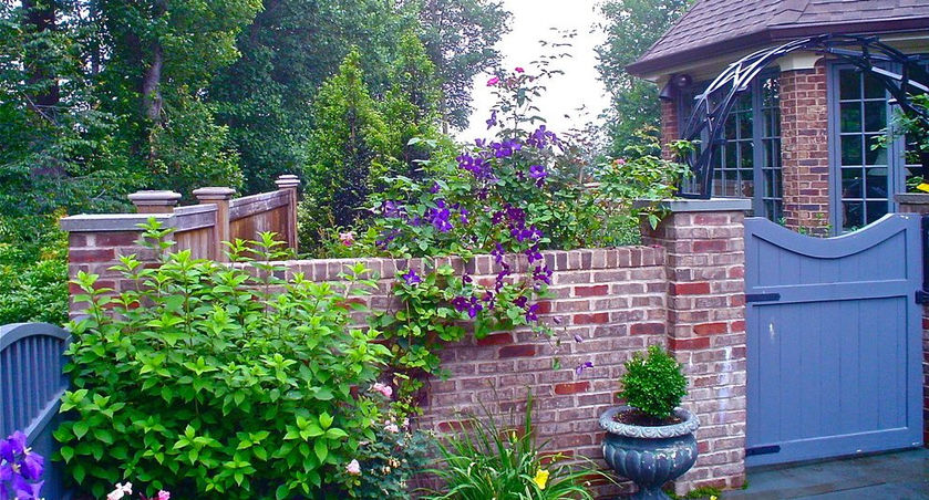 Brick wall, purple flowers, blue gate