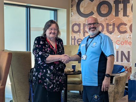 The handover of the role of Chairperson is sealed with a handshake