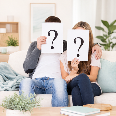 Man and woman considering whether they can be hypnotized with question marks around them