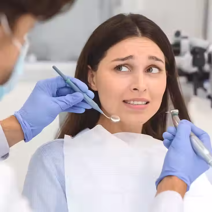 Woman at the dentist looking fearful