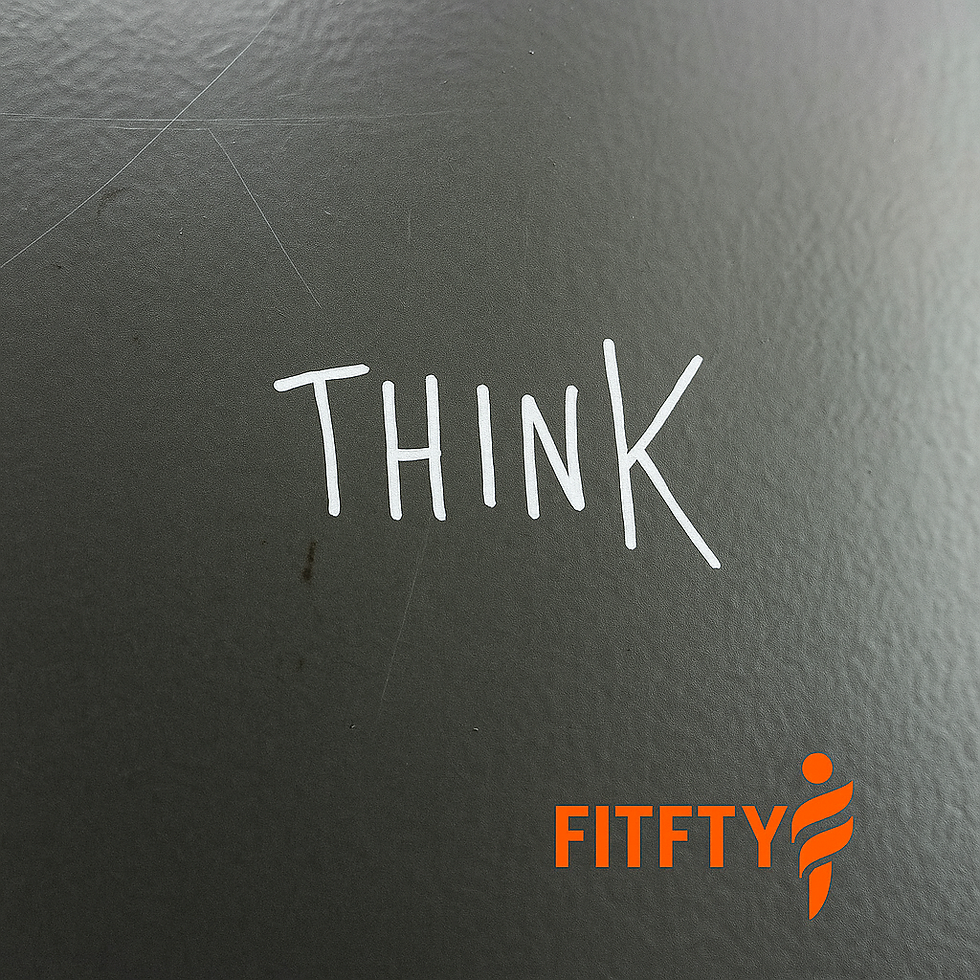 Minimalist photo featuring the handwritten word "THINK" on a grey textured surface, with the official Fitfty logo placed in the bottom right corner. The image symbolises reflective thinking and the intellectual foundation behind strength training and personal growth.