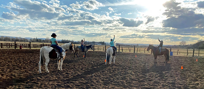 kids learning on horseback in the arena