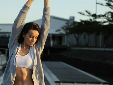 An image of a woman stretching happily after drinking a Drink This...nutrient drink