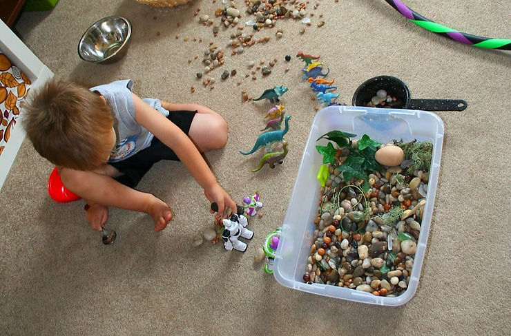 A child engaging in sensory play to support language development