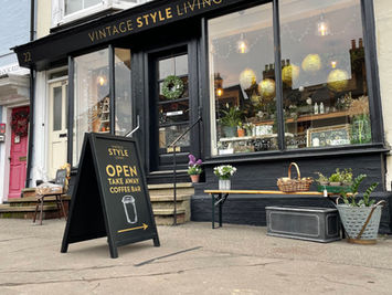 hand painted shop front on the high street with hand painted pavement board in front
